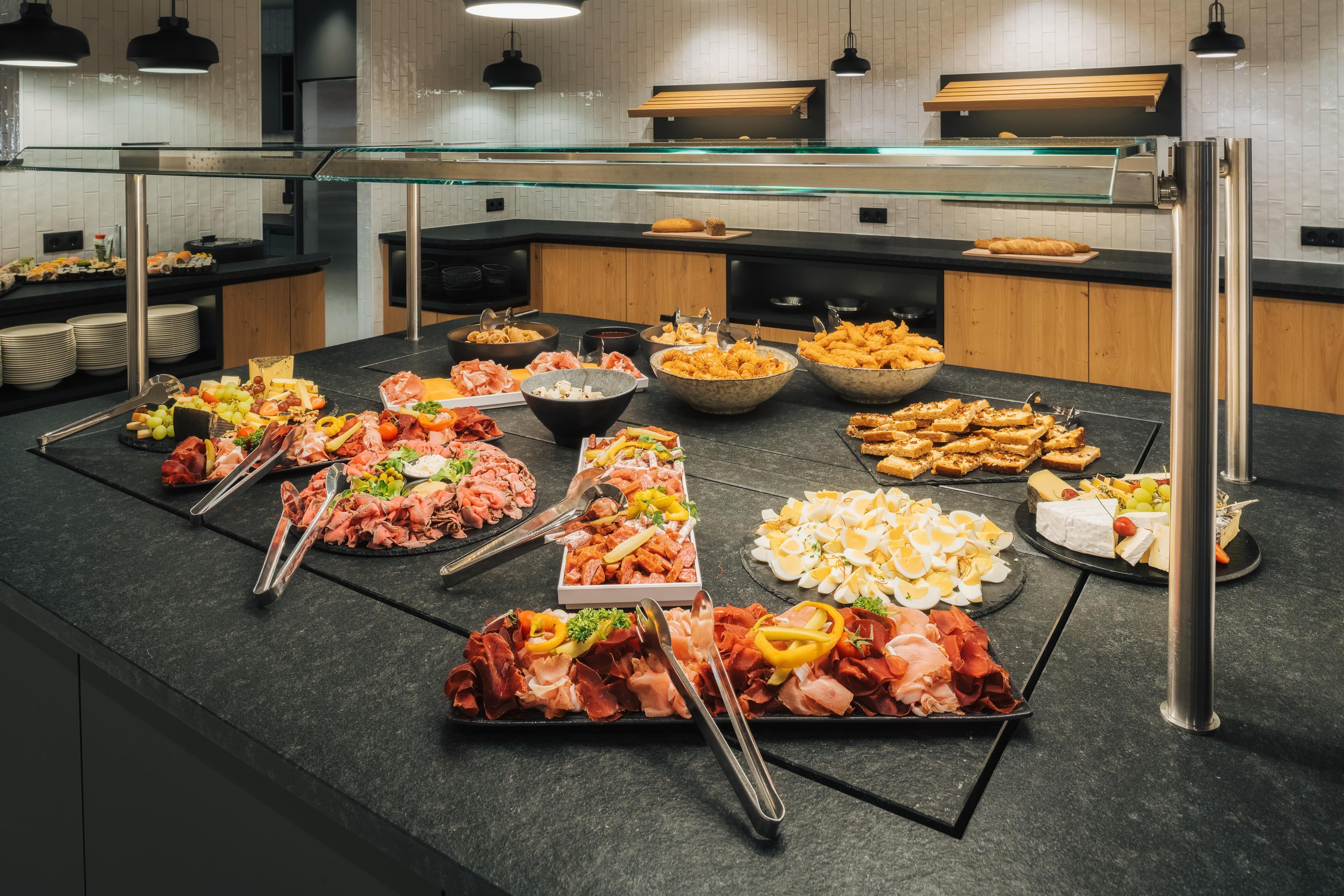 A lavish appetizer buffet with various antipasti including meat, fish, and vegetarian options.