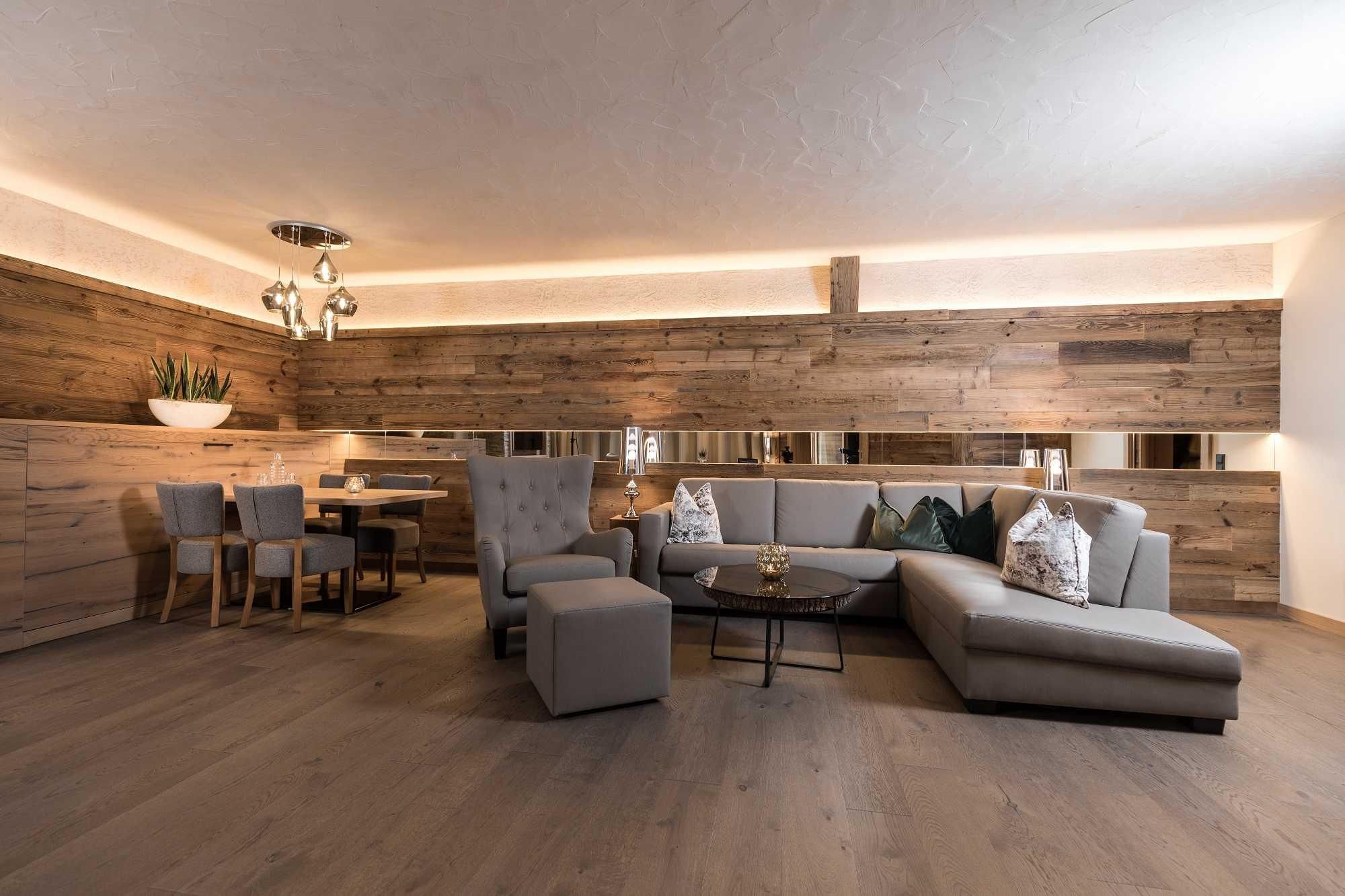 A modern living room with a bright wood interior. The cozy seating area and dining space create an inviting atmosphere.