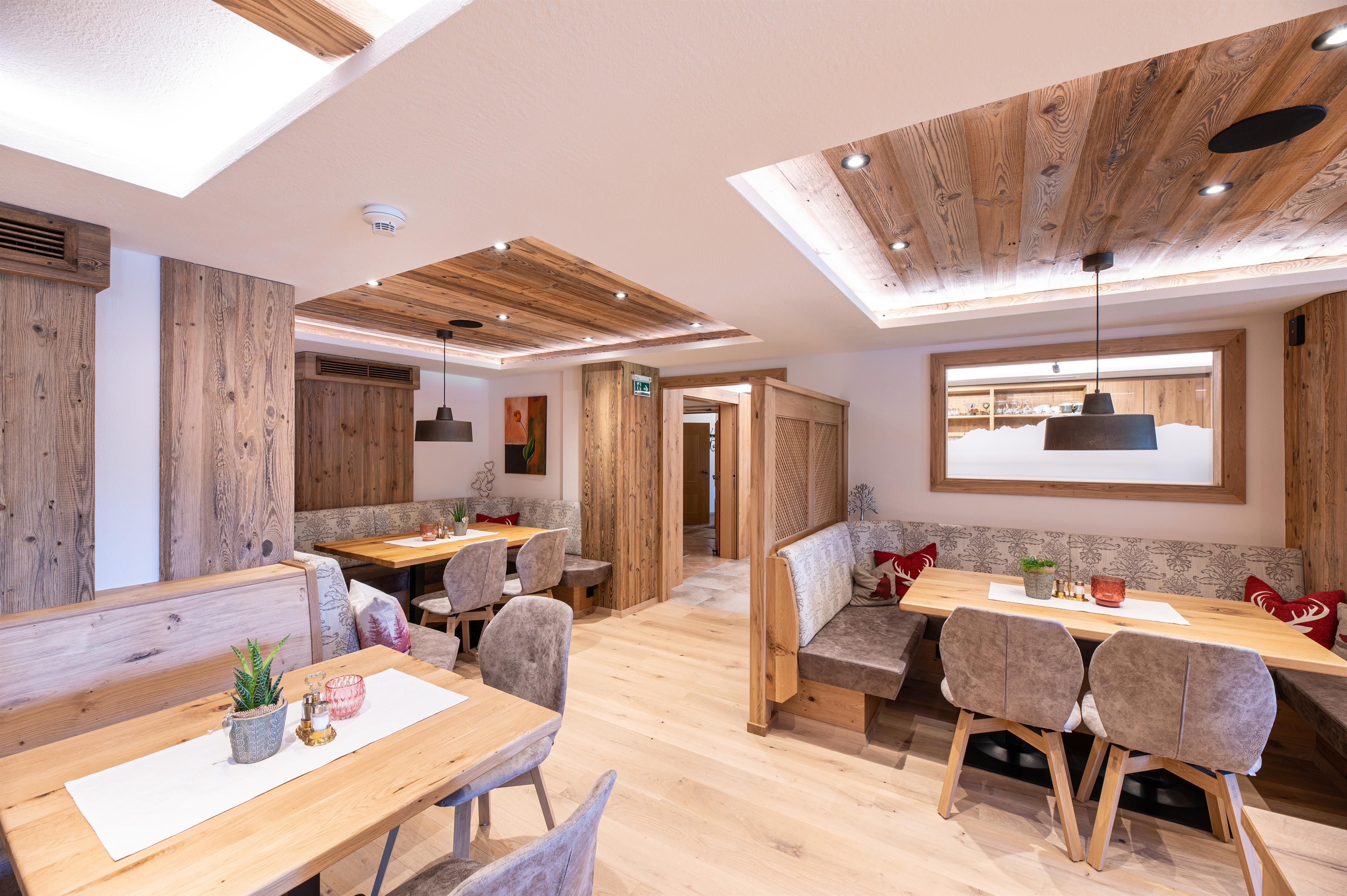 A cozy restaurant with wood-paneled walls and warm lighting. The tables are neatly set and invite you to linger.