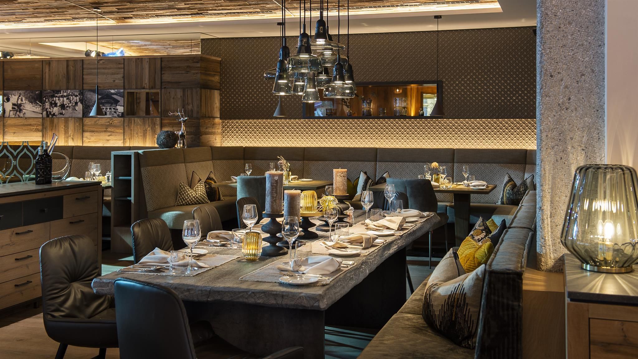 An elegant restaurant with tastefully set tables. The decor is modern and cozy, with soft lighting.
