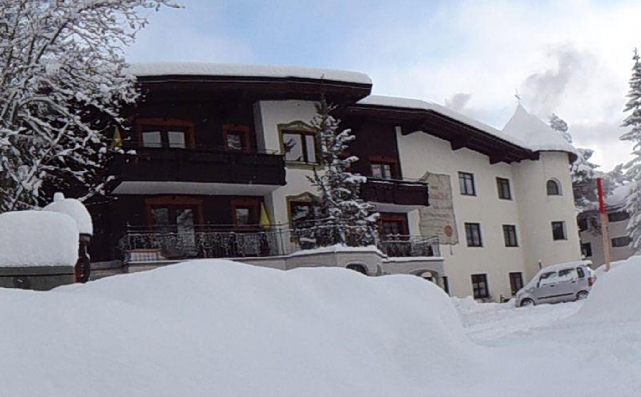 A charming building in winter, surrounded by deep snow. The surroundings are quiet and the trees are covered in snow.