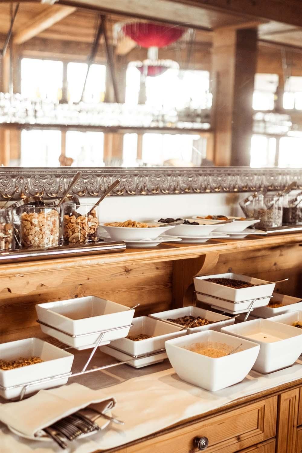 A beautifully set buffet area with several bowls for different foods. The atmosphere is cozy and inviting.