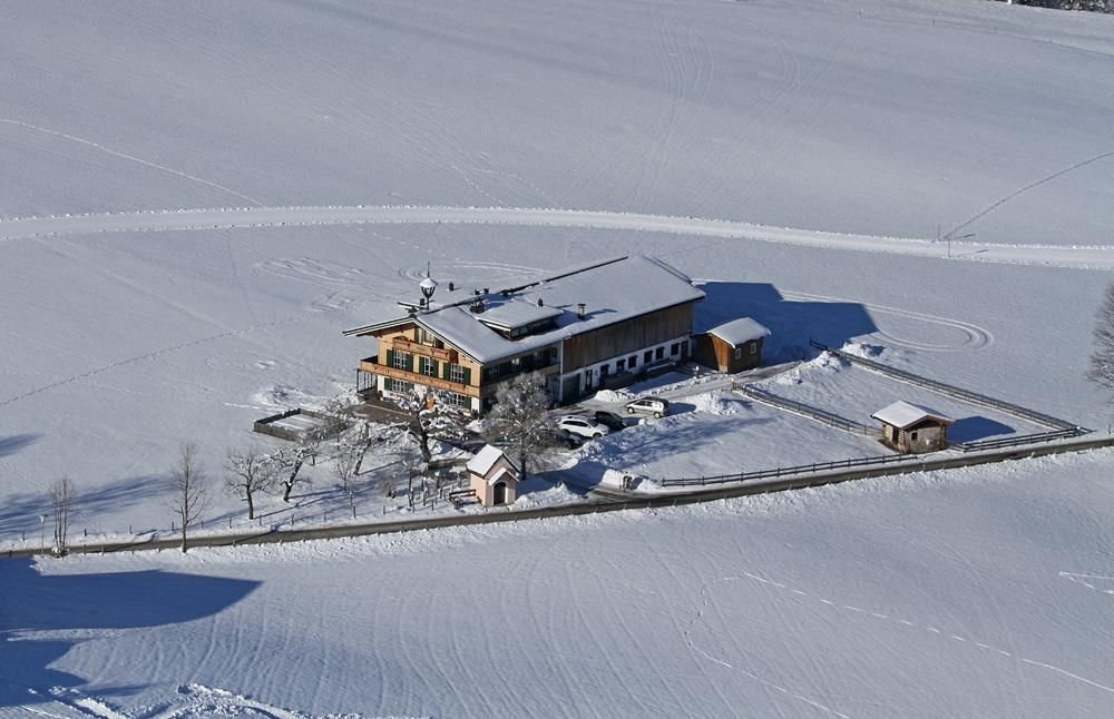 A beautiful snow-covered country house with a large garden. The landscape is peaceful and picturesque.