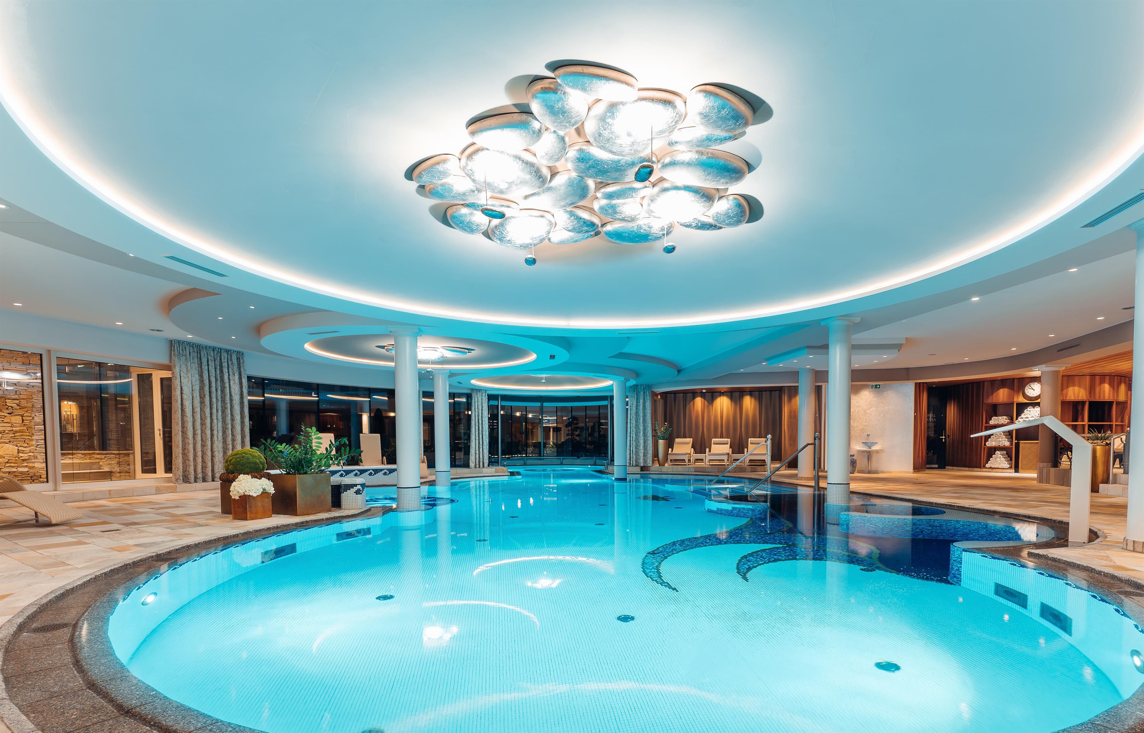 An elegant indoor pool with soft lighting and modern design. The surroundings are playful and invite relaxation.